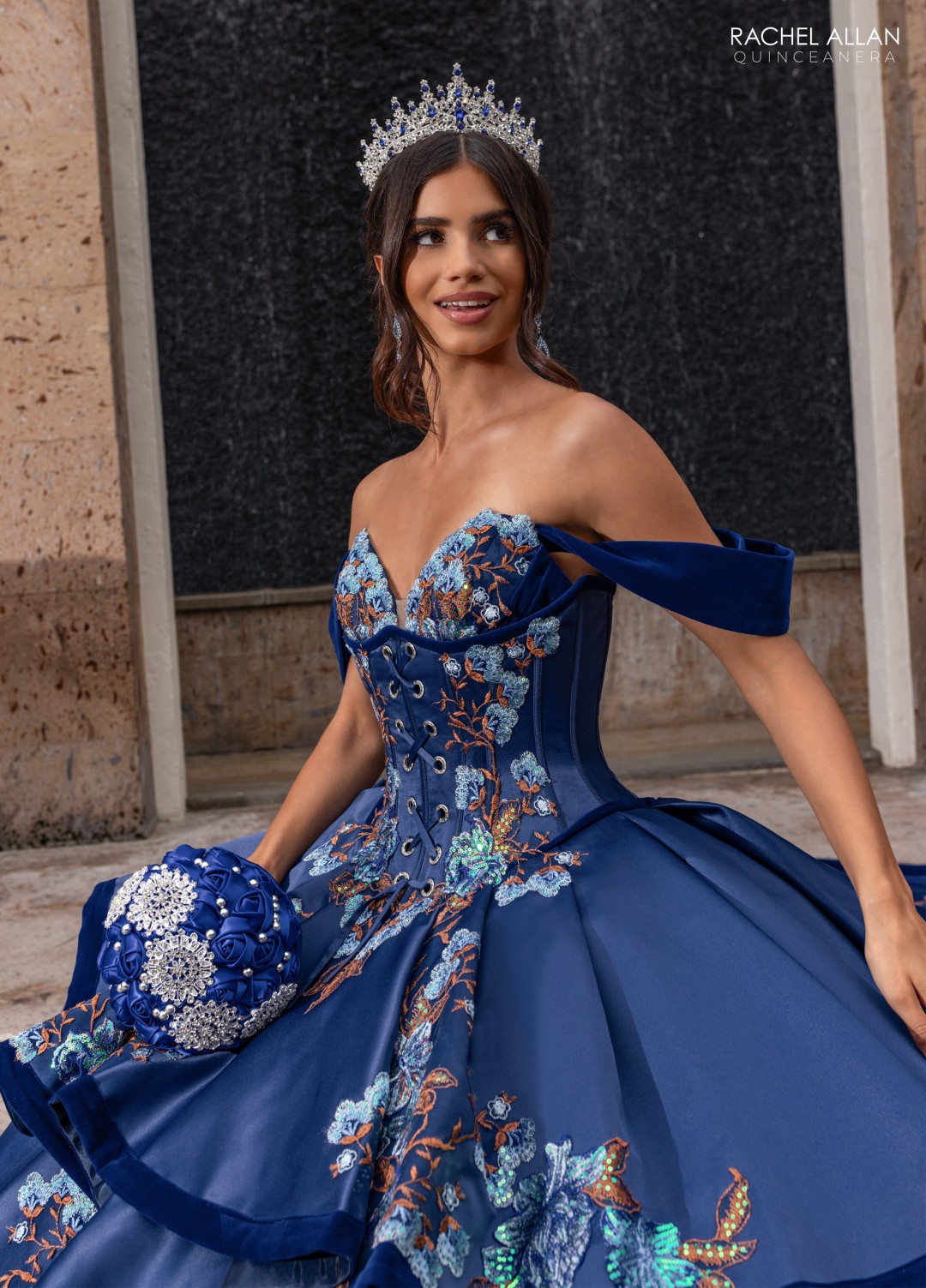 8.	Rachel Allan Style RQ5016 sweetheart charro ball gown in royal blue with bold floral sequin appliqués and tiered skirt